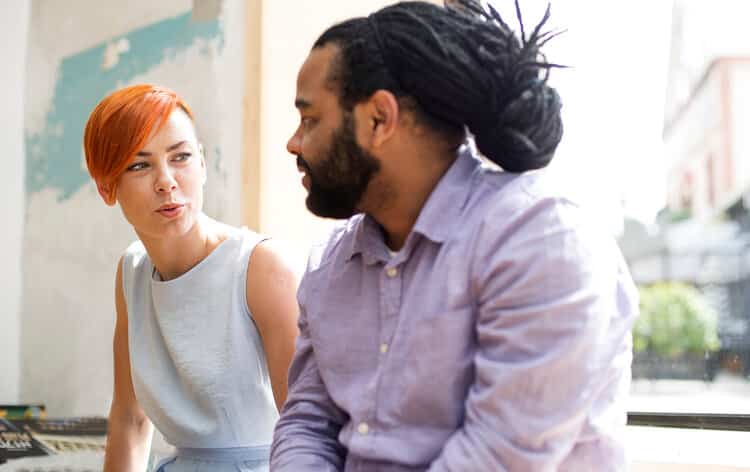 Redhaired young woman and black guy talking about boundaries