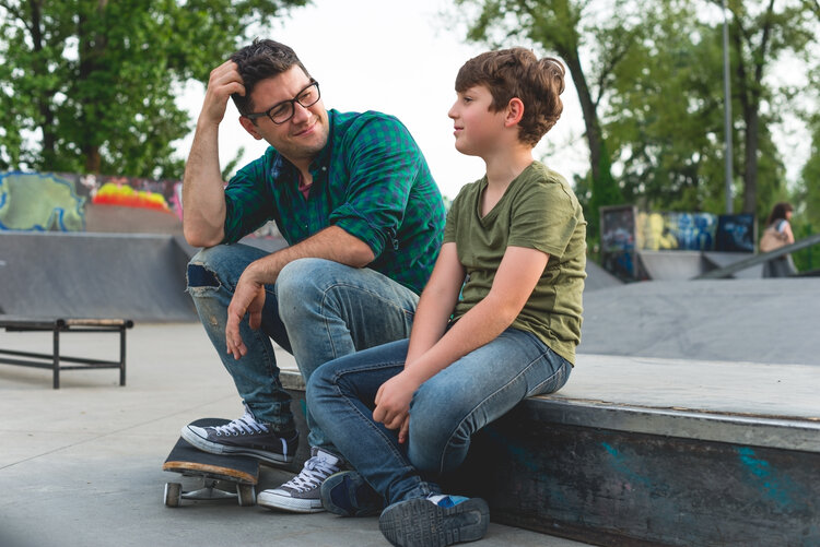 Dad and son talking. This Is The Important Way Understanding Emotions Improves Your Family